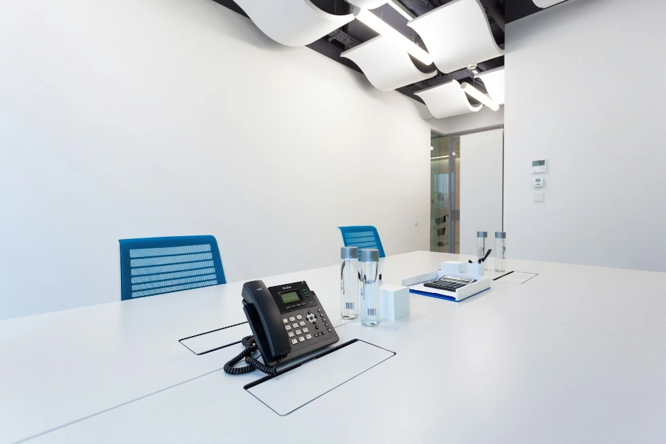 black ip desk phone on white table